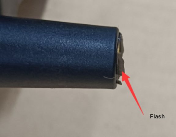 Flash or spew defect in injection molding